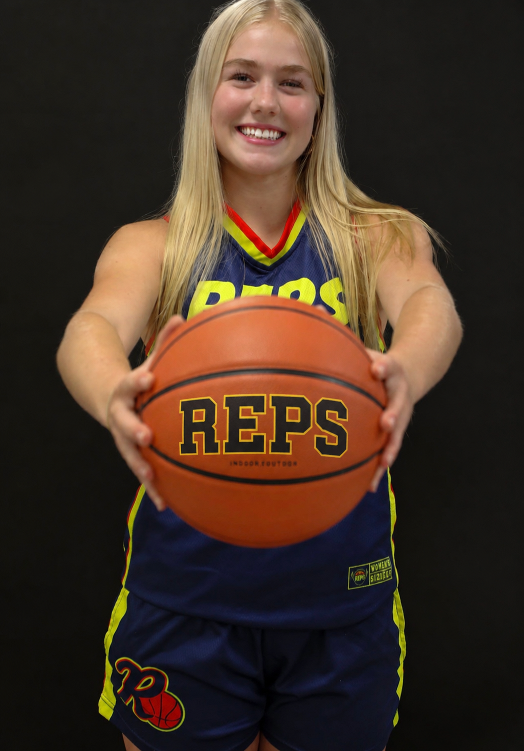 REPS Basketball player holding a REPS basketball